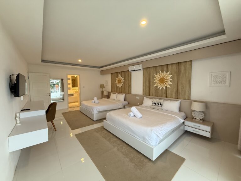 Bedroom with beds and wall decor at Panoramic Villa