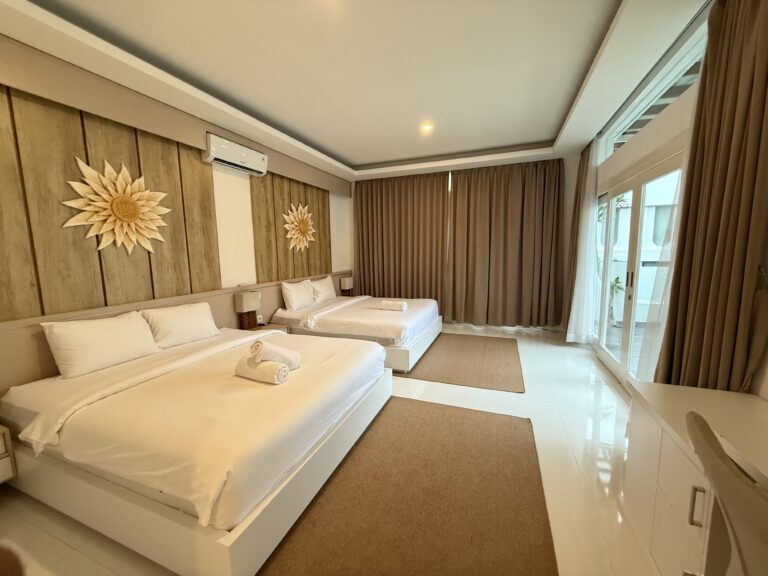 Bedroom with king-size bed and sunburst mirror at Panoramic Villa