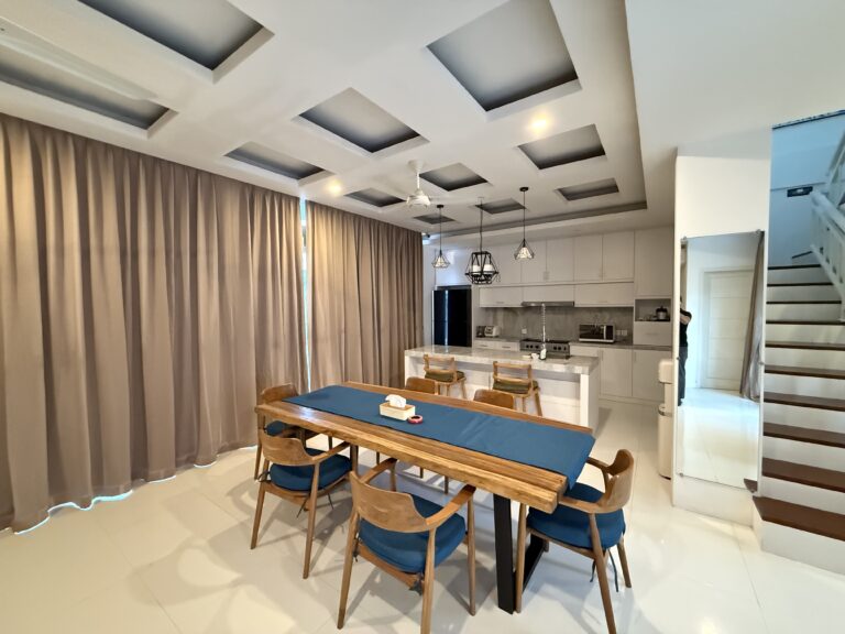 Dining table and staircase in the open-plan living area at Panoramic Villa