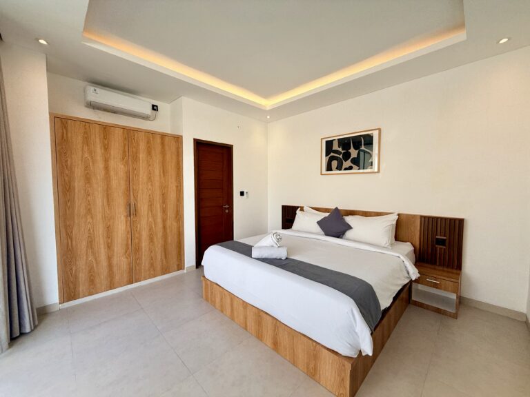 Second bedroom with king-size bed, wardrobe and bedside table