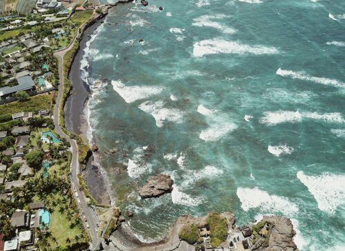 Aerial view of Canggu's black-sand coastline and surf breaks