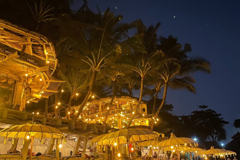 La Brisa beach club glowing with lanterns among palm trees at night, Echo Beach